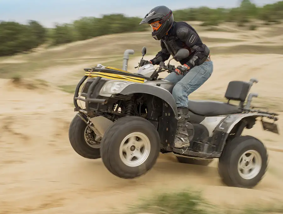 ATV rider wearing appropriate safety gear