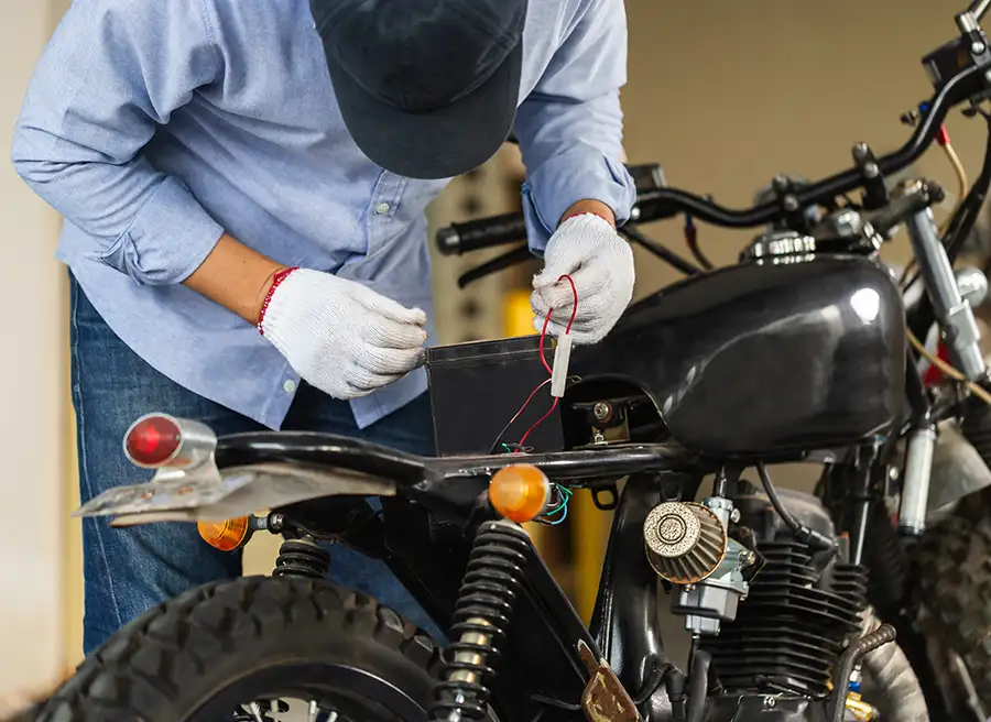 mechanic performs standard maintenance on motorcycle in shop - Carlinville, IL
