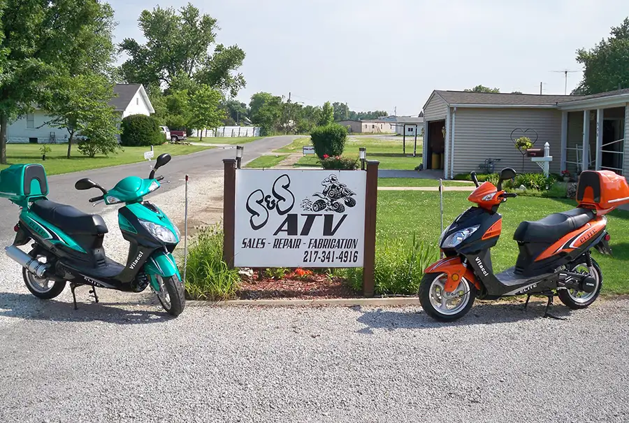 S&S ATV Sales & Services - two colorful vitacci elite scooters parked by shop sign, mopeds, motorcycles - Carlinville, IL